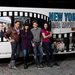 Passengers taking a photo in front of the On Location tour bus